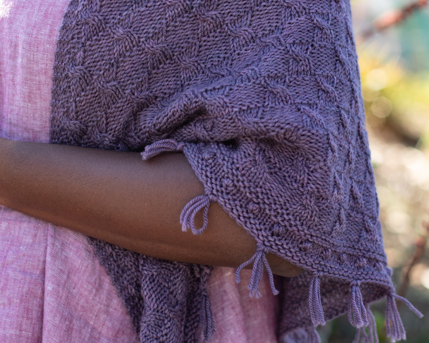 Woman wearing a deep purple handknit shawl