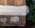 Unwound skein of undyed yarn and representative samples of the fiber contained in the yarn: merino and rambouillet wool